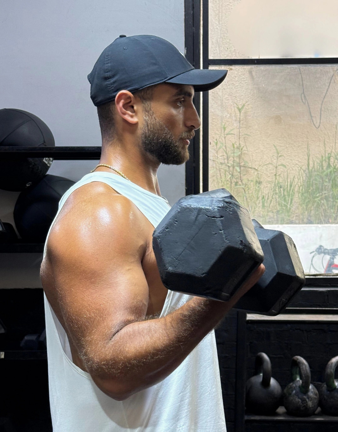 Ramez Asaad curling a heavy dumbbell