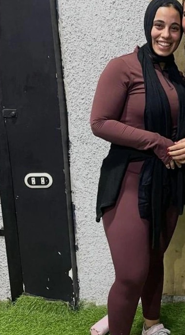 Client before coaching, in a maroon training set and black hijab