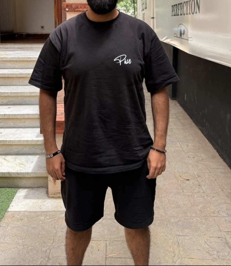 The same client nine months later, at 96 kg, in a black t-shirt and shorts