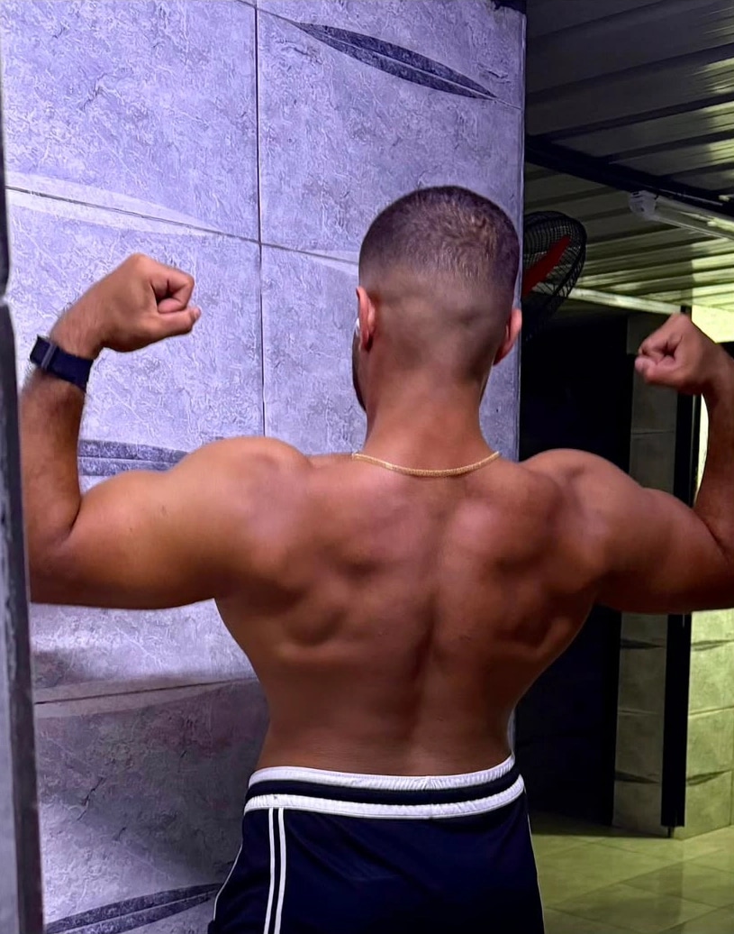 Ramez Asaad's back, after, flexing both arms